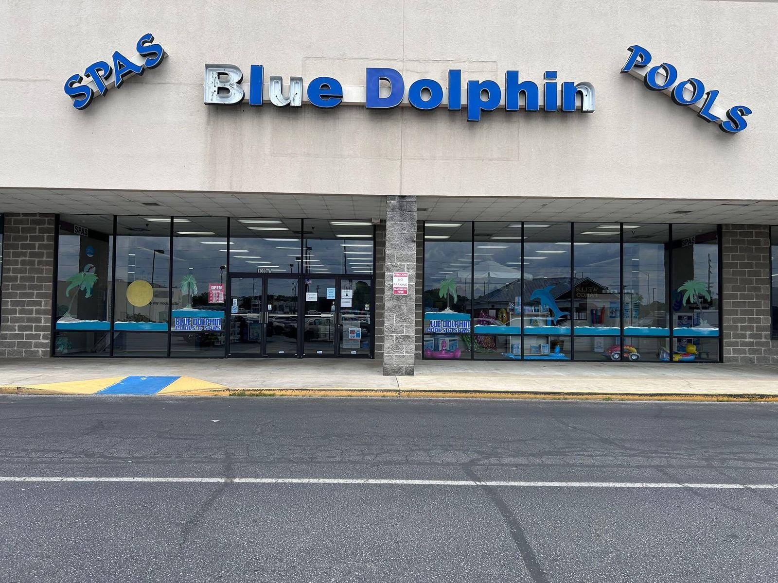 Blue Dolphin Pools and Spas storefront with clean glass