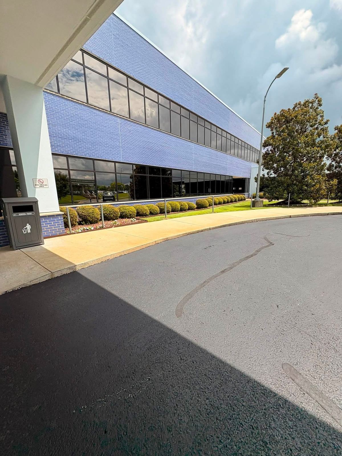 Large commercial facility exterior with floor-to-ceiling clean windows