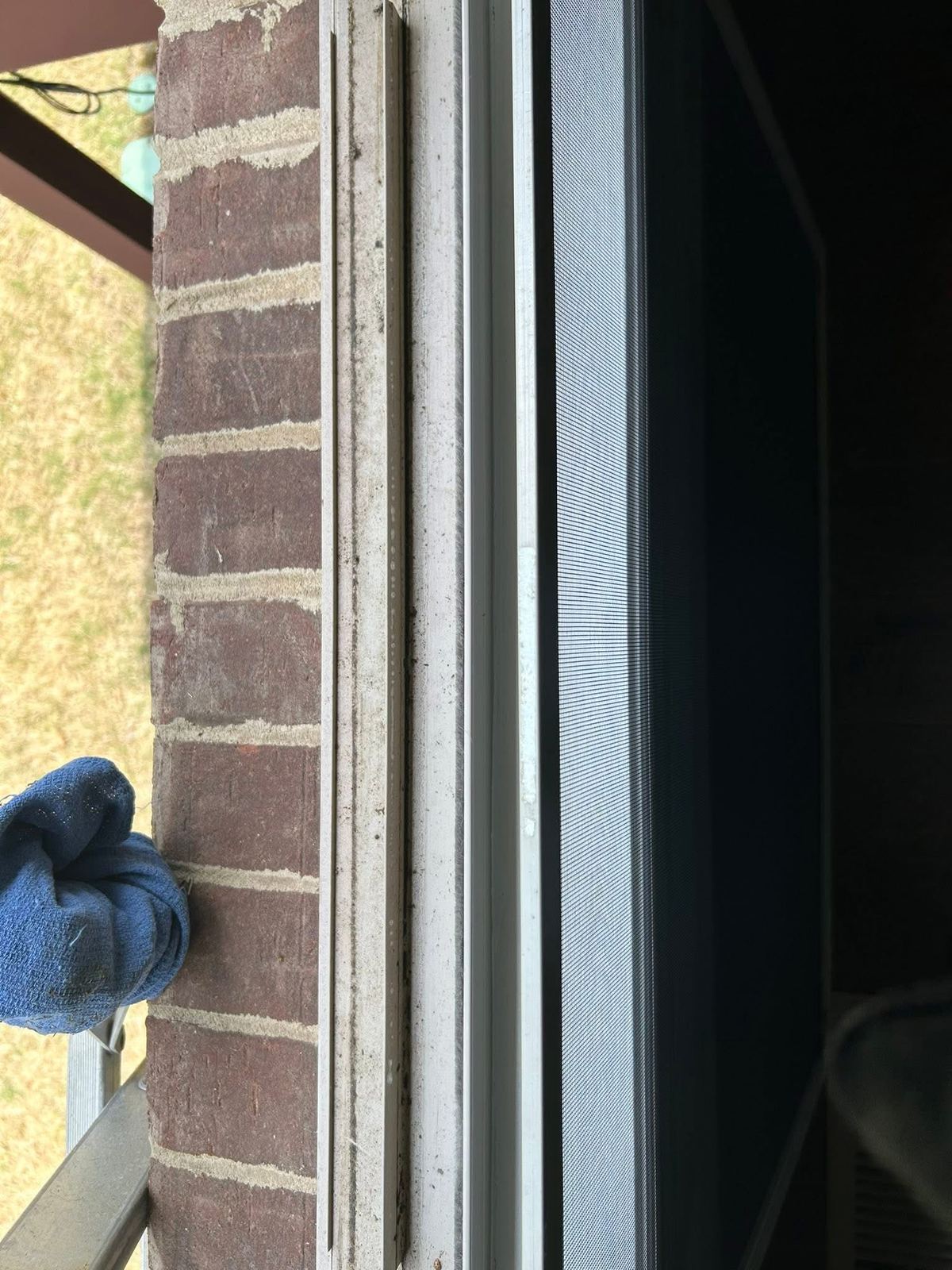 Close attention to detail cleaning a window frame and track by hand